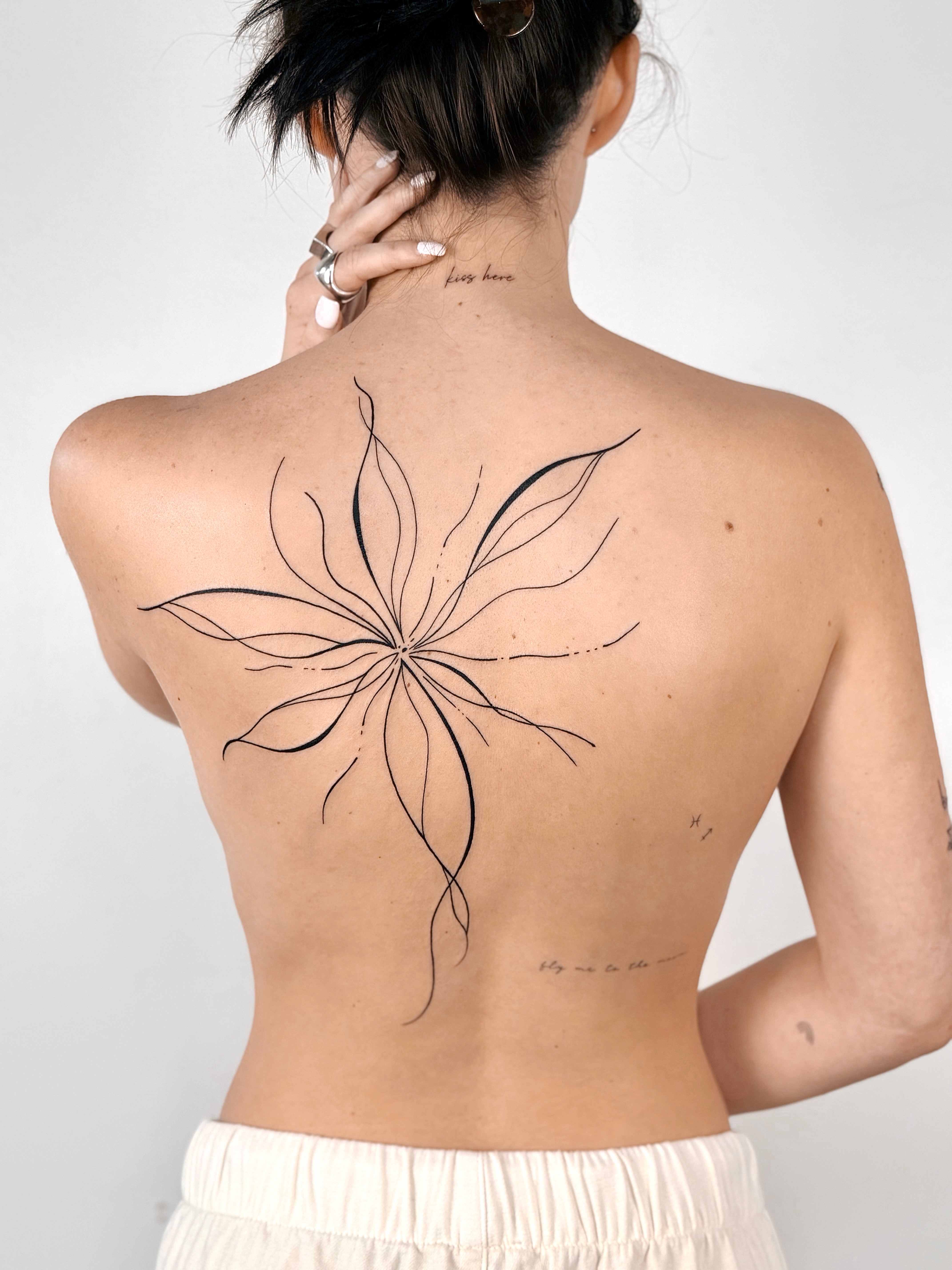 Large fine line abstract floral back tattoo by CHA